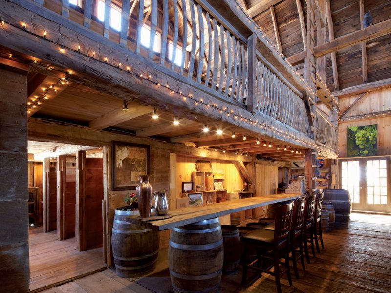 a large room with a bar and several stools.