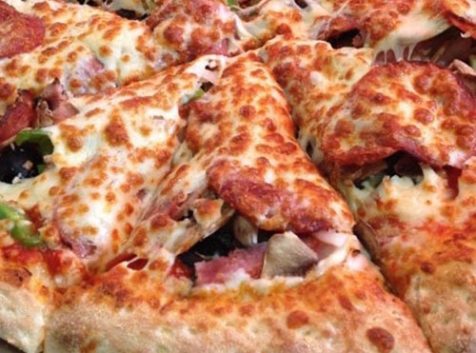 a pizza sitting on top of a pan on a table.
