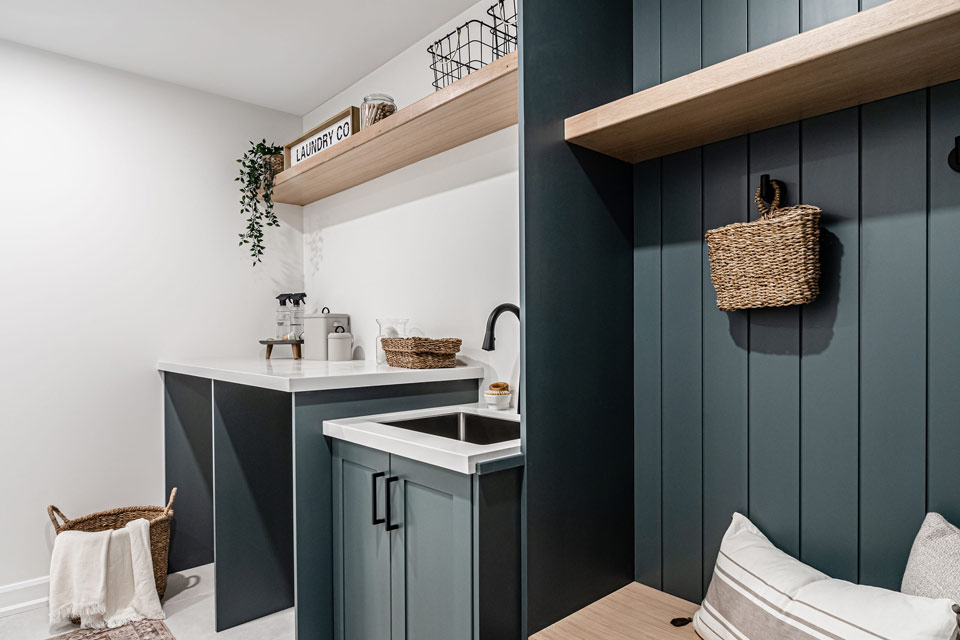 a kitchen area with a sink, cabinets and shelves.