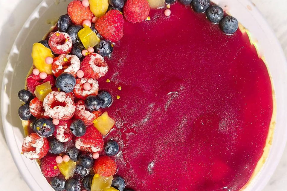 a bowl of fruit and a bowl of blueberries and raspberries.