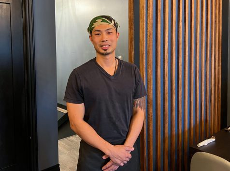 a man standing in front of a desk in a room.