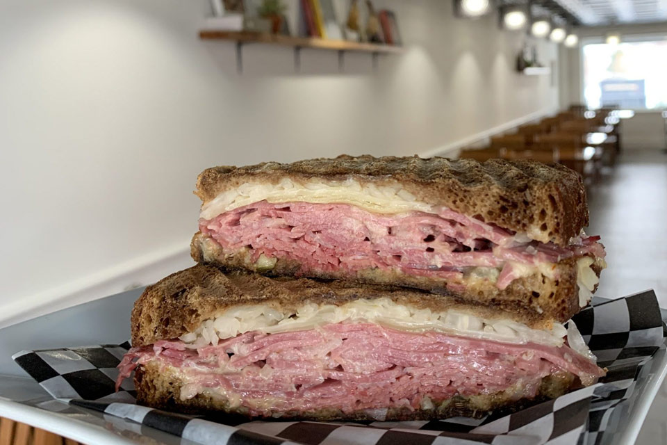 a cut in half sandwich sitting on top of a checkered plate.