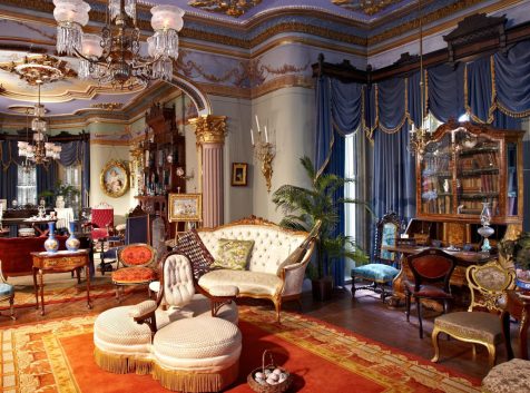 a living room filled with furniture and a chandelier.