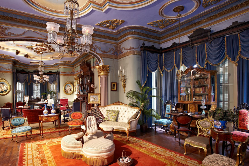 a living room filled with furniture and a chandelier.