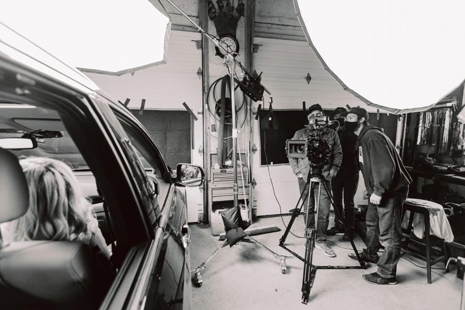 a black and white photo of a man with a camera.