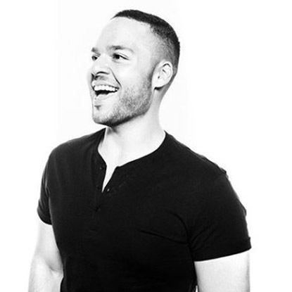 a black and white photo of a man laughing.
