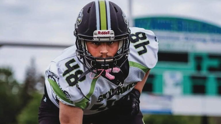 a young man wearing a football uniform and helmet.