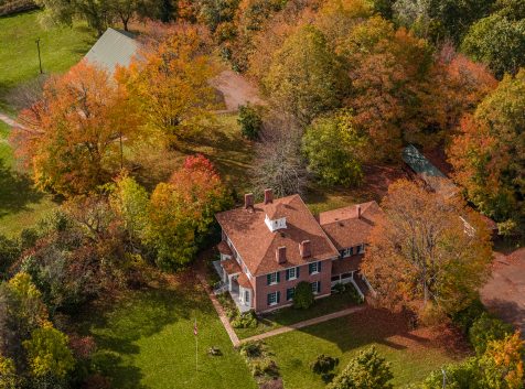 An aerial view of a house surrounded by trees.
