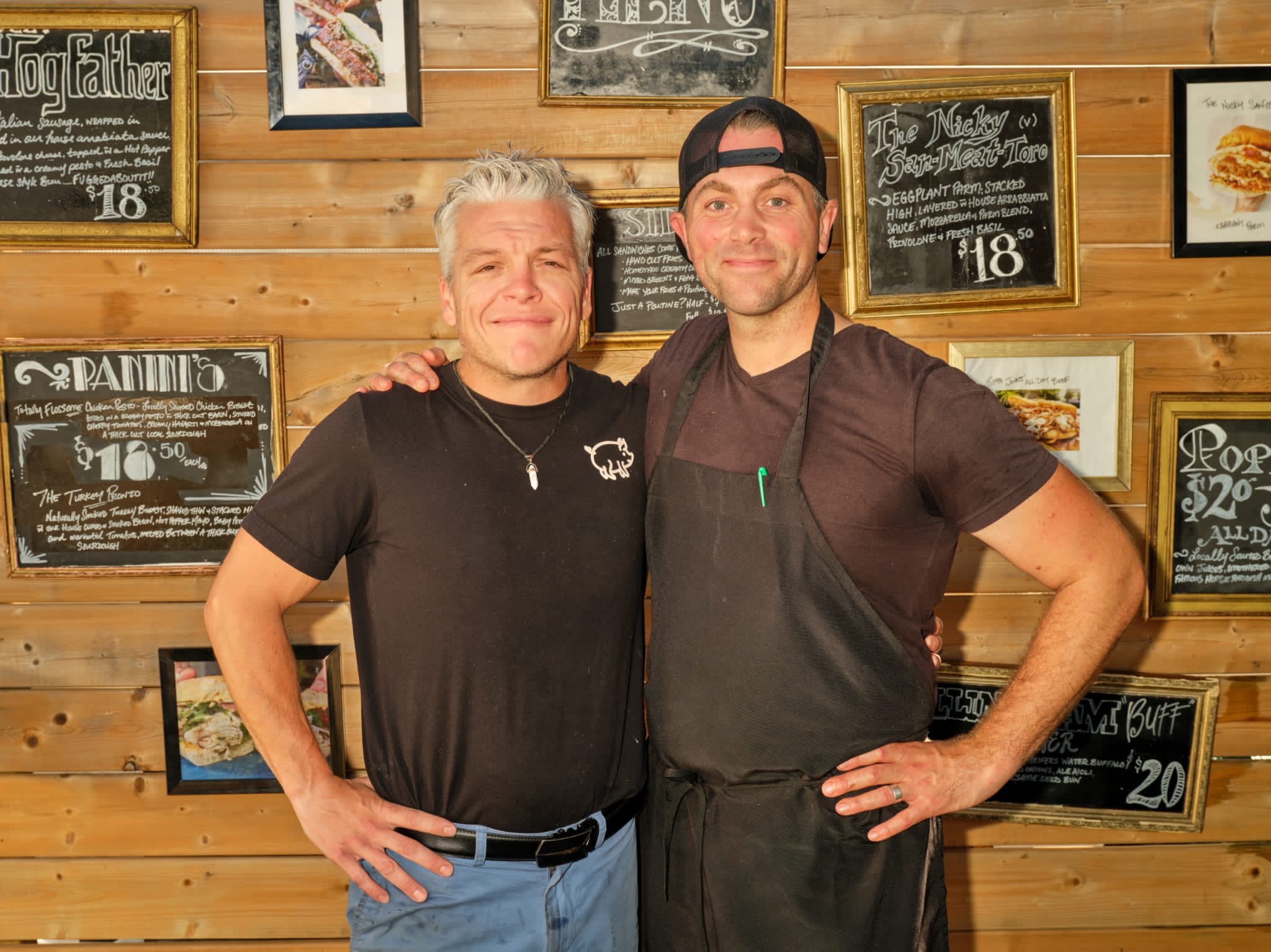 two men smiling and posed for the camera