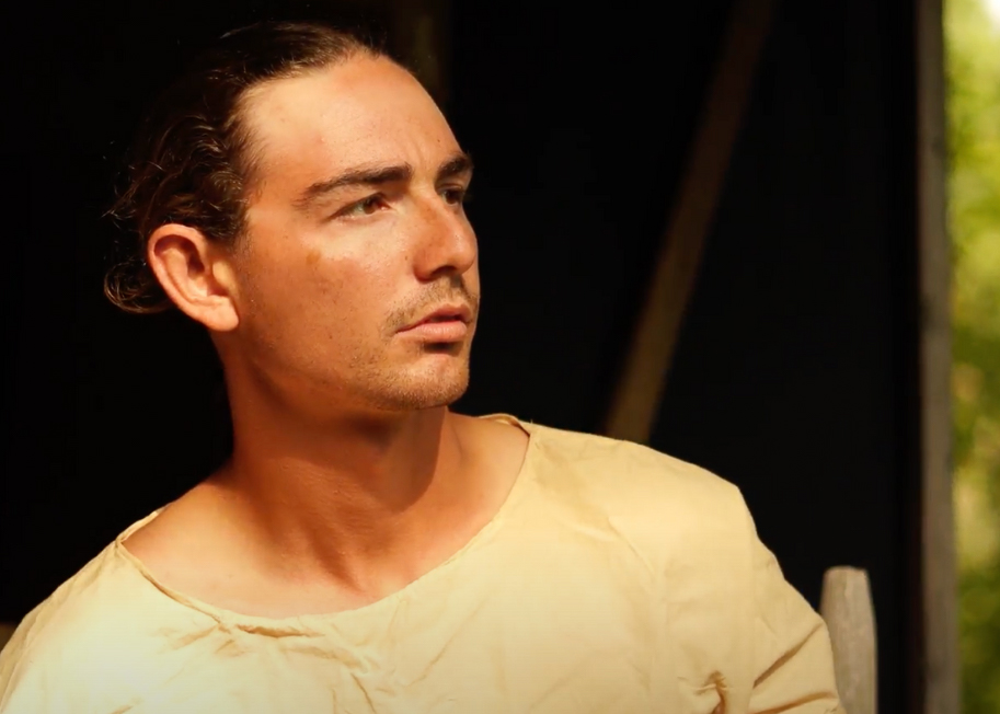 a man in plain clothes with a serious look on his face