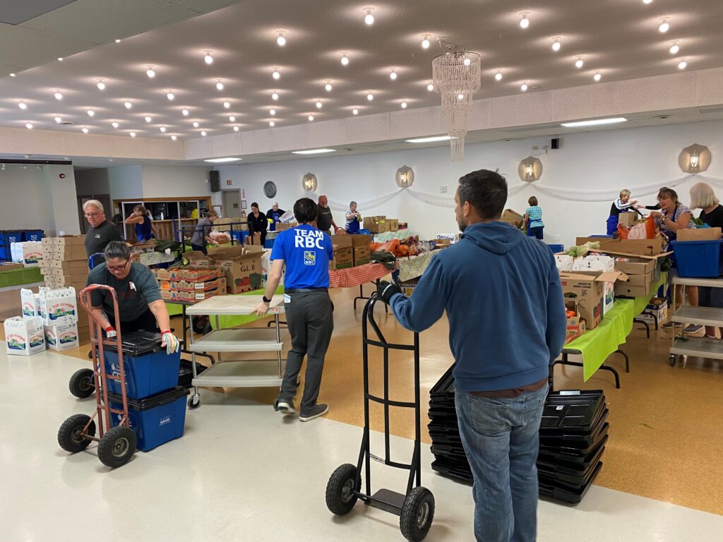 a group of volunteers packing food hampers for donation