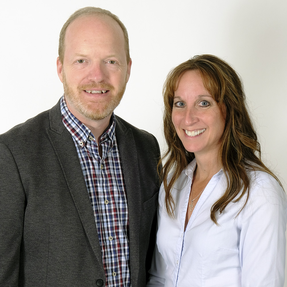 a man and woman posing for a headshot