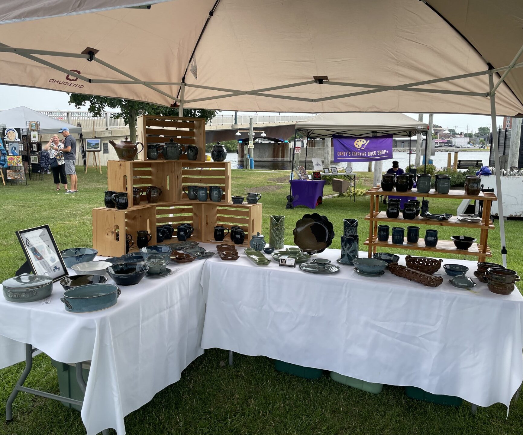 a display tent at an art show full of ceramic pieces