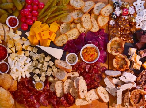 overhead image of a charcuterie board that shows meats, cheeses, spreads and treats from bay of quinte region businesses