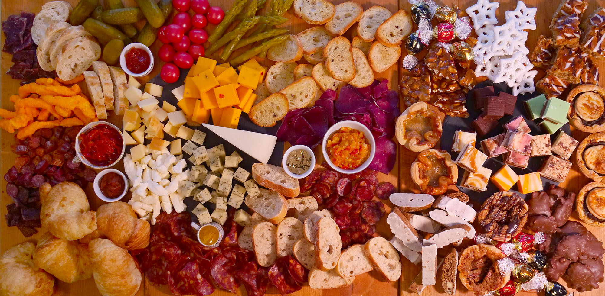 overhead image of a charcuterie board that shows meats, cheeses, spreads and treats from bay of quinte region businesses