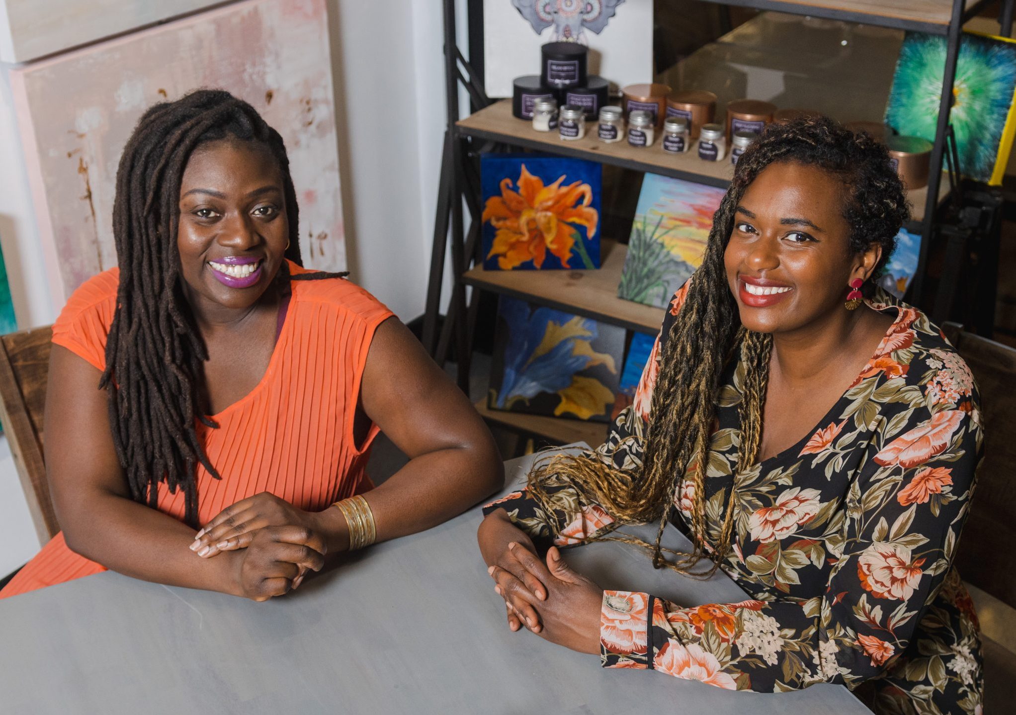 two women sitting and posing for a photo