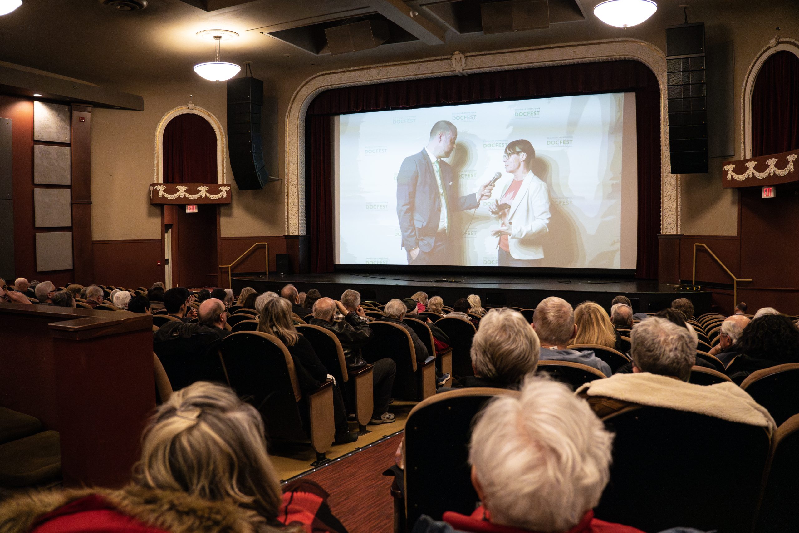 an audience in a theatre watching a film