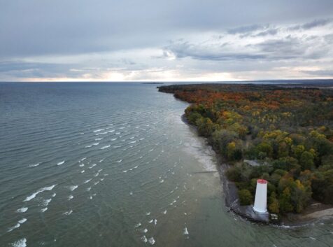 Aerial image of a wooded park with a lighthouse