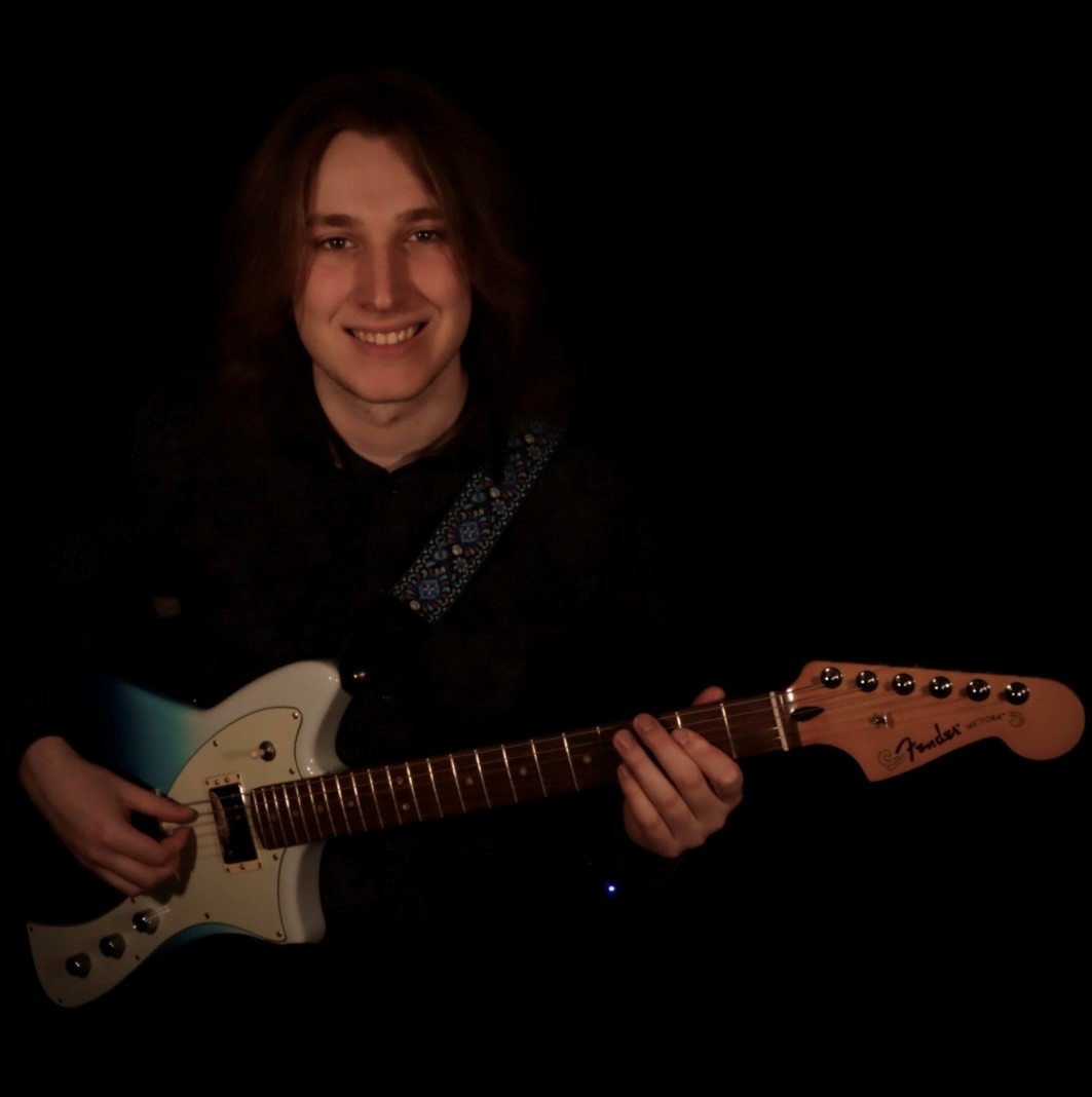 guy smiling with guitar