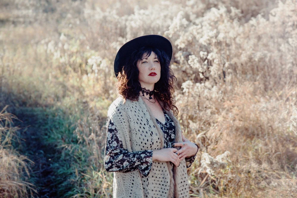 woman in field with big hat